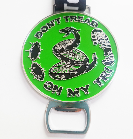 engraved medal with green coloring